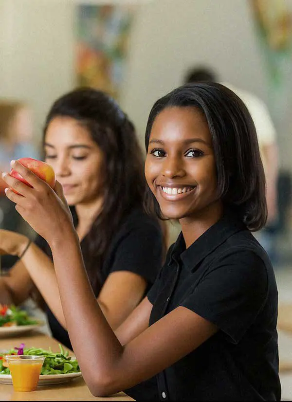 Two students eating in cafeteria